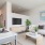 TV Mounted to Wall Next to White Couch
